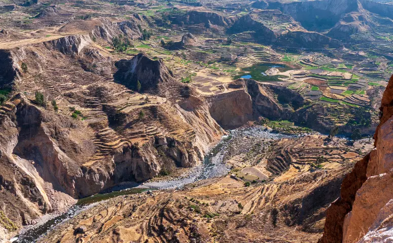 Colca canyon surrounded high mountain walls with Exploor Peru
