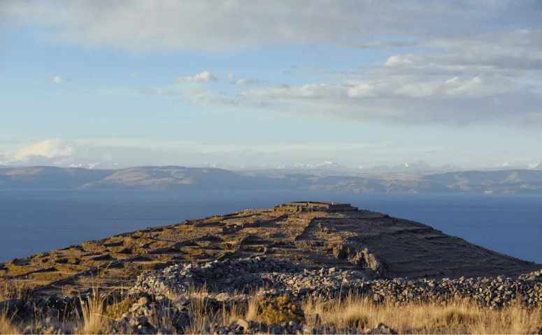 Green hill and view on lake titicaca with Exploor Peru