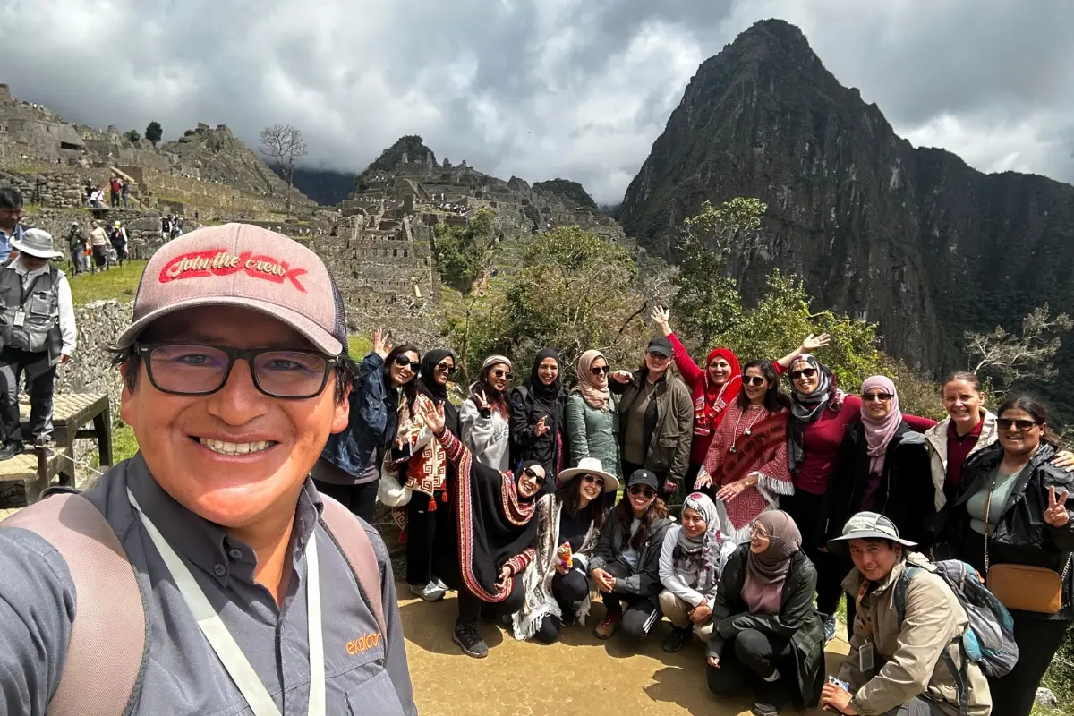 exploor peru guide with group at machu picchu